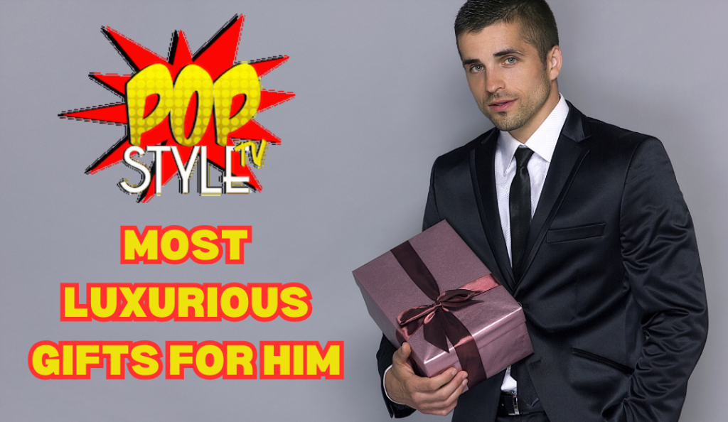 Man in suit holding a burgundy gift