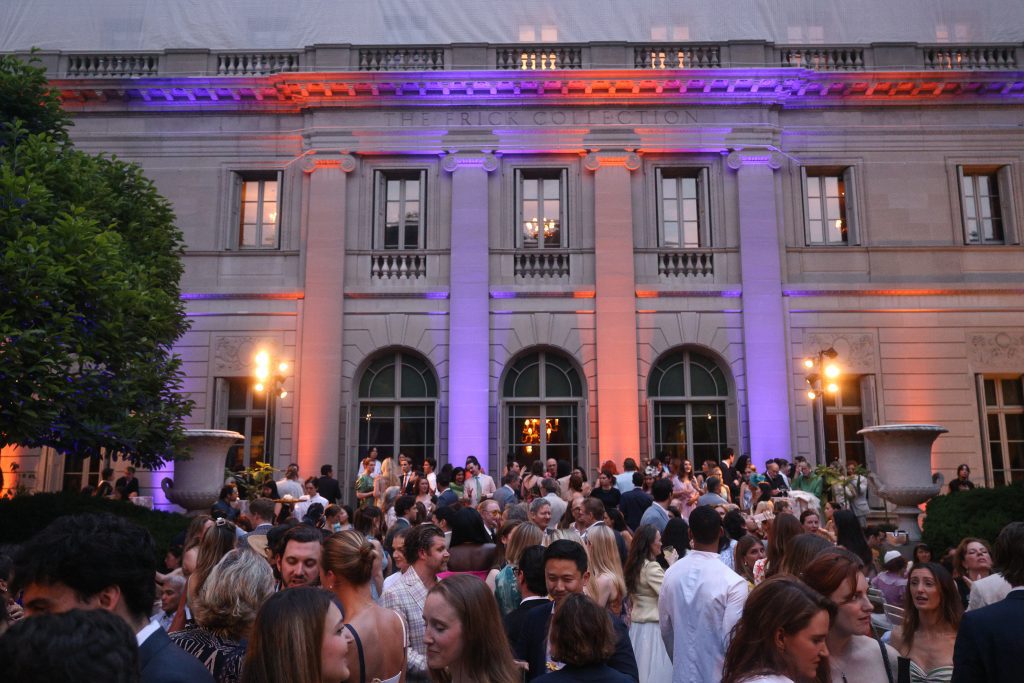 Guests in the Fifth Avenue Garden at the Spring Garden Party, with a special blue-and-orange lighting display in honor of the New York Knicks; photo: Matteo Prandoni/BFA.com