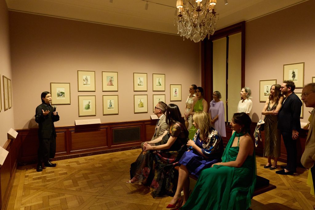 Anne L. Poulet Curatorial Fellow Yifu Liu presenting a gallery talk on Ruffles & Ribbons: FashionPlates from the Time of Marie Antoinette at the Spring Garden Party; photo: George Koelle